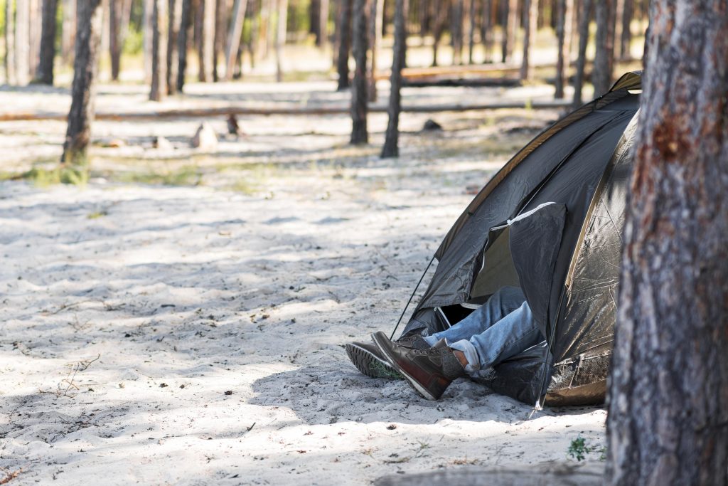 side view man s legs outside tent scaled